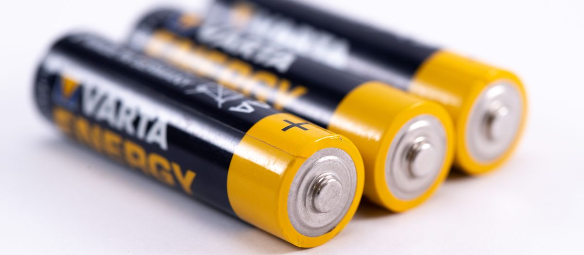 High-quality image showcasing a close-up view of three alkaline batteries on a white surface.